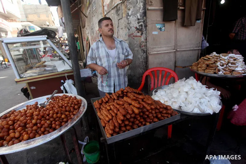 A Palestinian vendor displays his goods at a market in Gaza city on Aug 13,2012, as Muslims over the world prepare to celebrate Eid al-Fitr, a three day holiday marking the end of the religious month of Ramadan in which...