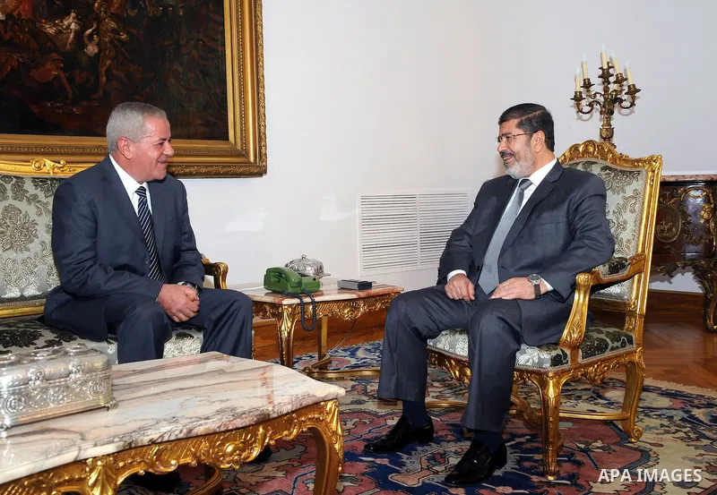 Egypt's President Mohamed Mursi (R) meets with Egypt's newly appointed Minister of State for Military Production Reda Mahmoud Hafez Abdel Maguid at the presidential palace in Cairo, August 13, 2012. Mursi has driven back...