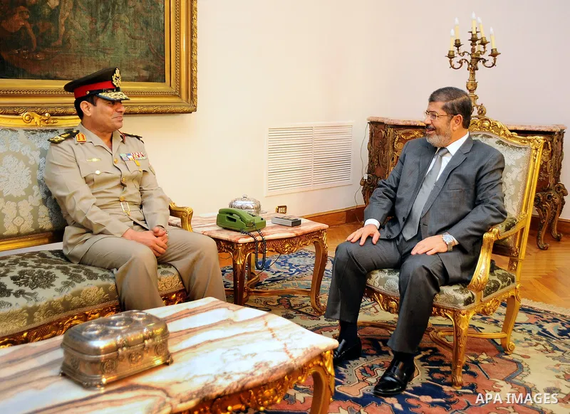Egypt's President Mohamed Mursi (R) meets with Egypt's new Defence Minister Abdel Fattah al-Sissi at the presidential palace in Cairo, August 13, 2012. Mursi has driven back the biggest challenge to civilian rule by dism...