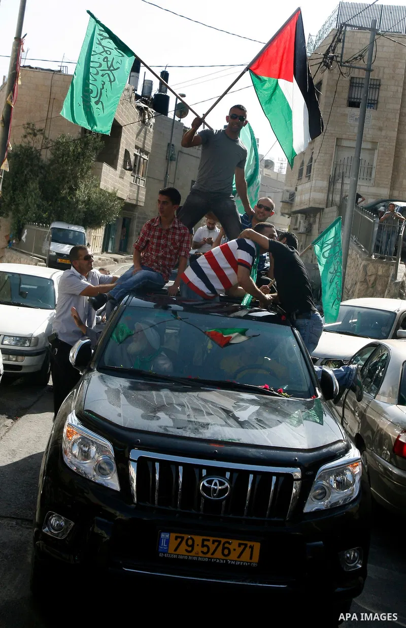 Palestinians celebrate after the Israeli authorities released prisoner Aws Ibrahim Hamada in neighborhood of Sour Baher in Jerusalem on Aug 13, 2012. Hamada spent 10 years in prison before the Israeli authorities release...
