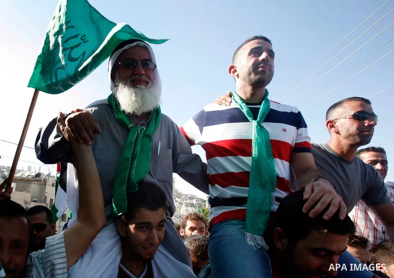 Palestinians celebrate after the Israeli authorities released prisoner Aws Ibrahim Hamada in neighborhood of Sour Baher in Jerusalem on Aug 13, 2012. Hamada spent 10 years in prison before the Israeli authorities release...