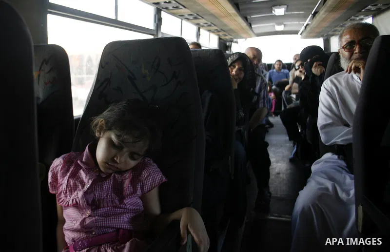 Palestinian passengers wait at a station in Khan Younis in the southern Gaza Strip, before entering Egypt through Rafah border crossing August 14, 2012. Egypt opened the crossing temporarily on Tuesday, but just for thre...