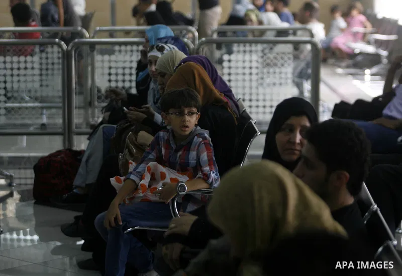 Palestinian passengers wait at a station in Khan Younis in the southern Gaza Strip, before entering Egypt through Rafah border crossing August 14, 2012. Egypt opened the crossing temporarily on Tuesday, but just for thre...