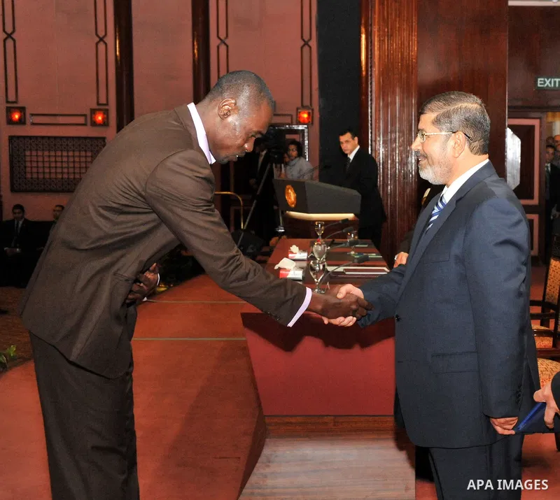 Egypt's President Mohamed Mursi, presents a prize to a youth who won the Conservation of the Holy Koran contest during the Laylat al-Qadr at Egypt Al-Azhar Conference Center at Nasr City in Cairo August 12, 2012. Egypt's...
