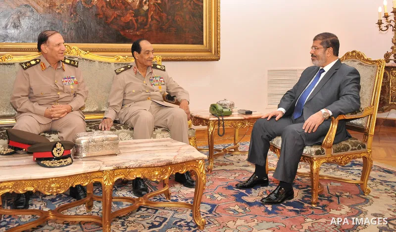 Egyptian president Mohamed Morsi (R) meeting with retired former Defence Minister and Field Marshall Hussein Tantawi (C), and retired Armed Forces Chief of Staff, Sami Anan (L) at the presidential palace in Cairo on Augu...