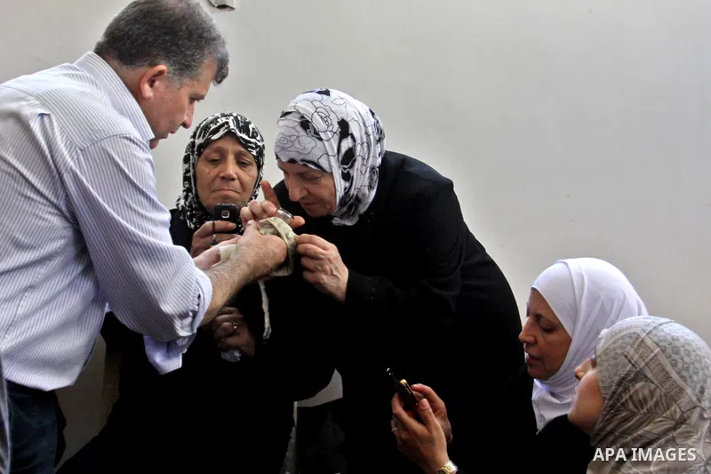 Palestinian Muslim touch a hair of Prophet Mohammed in the 27th Day of the holy month of Ramadan at a mosque in the West Bank city of Nablus, August 15, 2012. 27th Ramadan is the Islamic event of Night of Decree, known a...