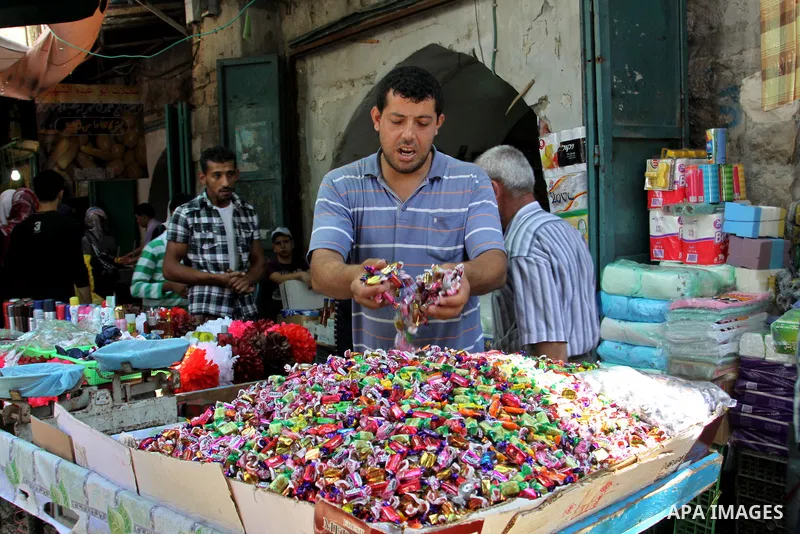 A Palestinian vendor displays his goods in the main market during preparations for the Eid Al-Fitr feast in the West Bank city of Nablus on Aug 16, 2012, as Muslims over the world prepare to celebrate Eid al-Fitr, a thre...