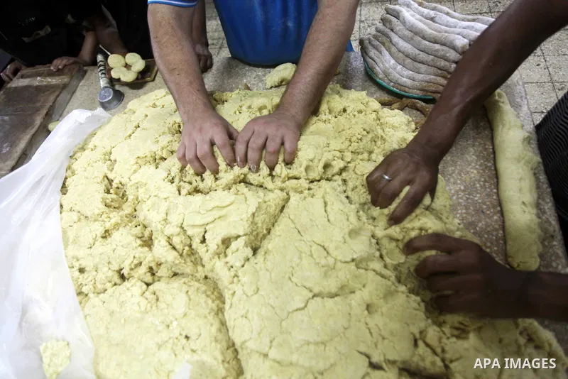 Palestinian workers make traditional date-filled cookies in preparation for the Eid al-Fitr holiday at bakery in the Gaza Strip on August 16, 2012. Muslims around the world are preparing to celebrate the Eid al-Fitr holi...