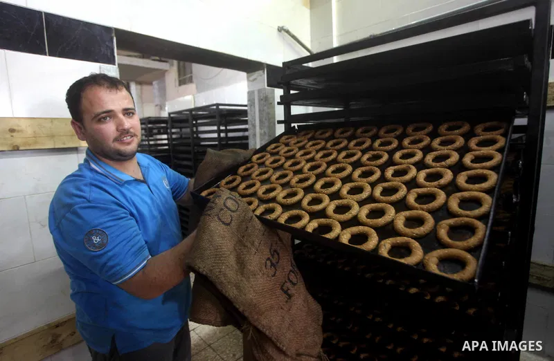 Palestinian workers make traditional date-filled cookies in preparation for the Eid al-Fitr holiday at bakery in the Gaza Strip on August 16, 2012. Muslims around the world are preparing to celebrate the Eid al-Fitr holi...