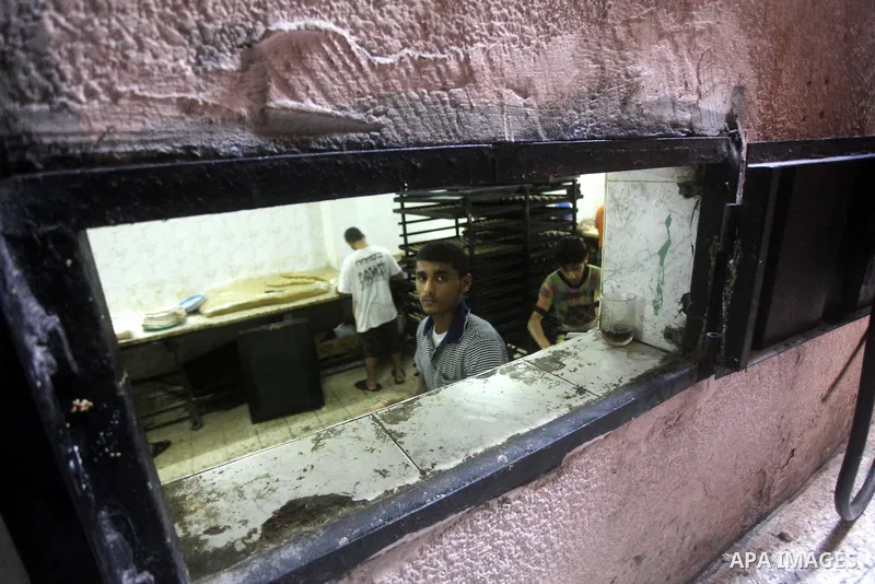 Palestinian workers make traditional date-filled cookies in preparation for the Eid al-Fitr holiday at bakery in the Gaza Strip on August 16, 2012. Muslims around the world are preparing to celebrate the Eid al-Fitr holi...