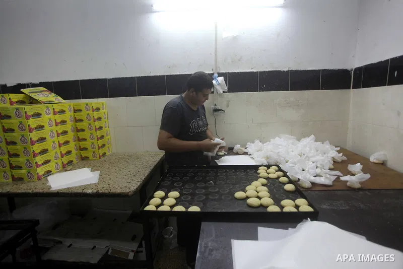 Palestinian workers make traditional date-filled cookies in preparation for the Eid al-Fitr holiday at bakery in the Gaza Strip on August 16, 2012. Muslims around the world are preparing to celebrate the Eid al-Fitr holi...