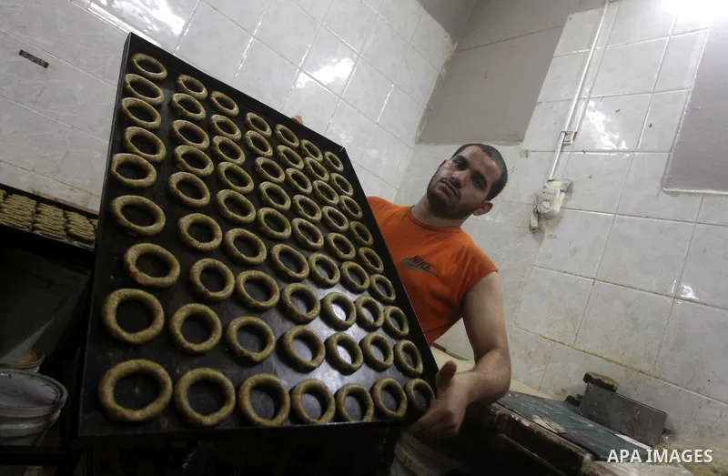 Palestinian workers make traditional date-filled cookies in preparation for the Eid al-Fitr holiday at bakery in the Gaza Strip on August 16, 2012. Muslims around the world are preparing to celebrate the Eid al-Fitr holi...