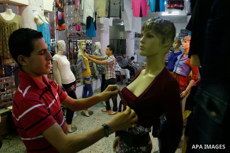A Palestinian vendor displays his goods at a market in the southern Gaza strip town of Rafah on Aug 16,2012, as Muslims over the world prepare to celebrate Eid al-Fitr, a three day holiday marking the end of the religiou...