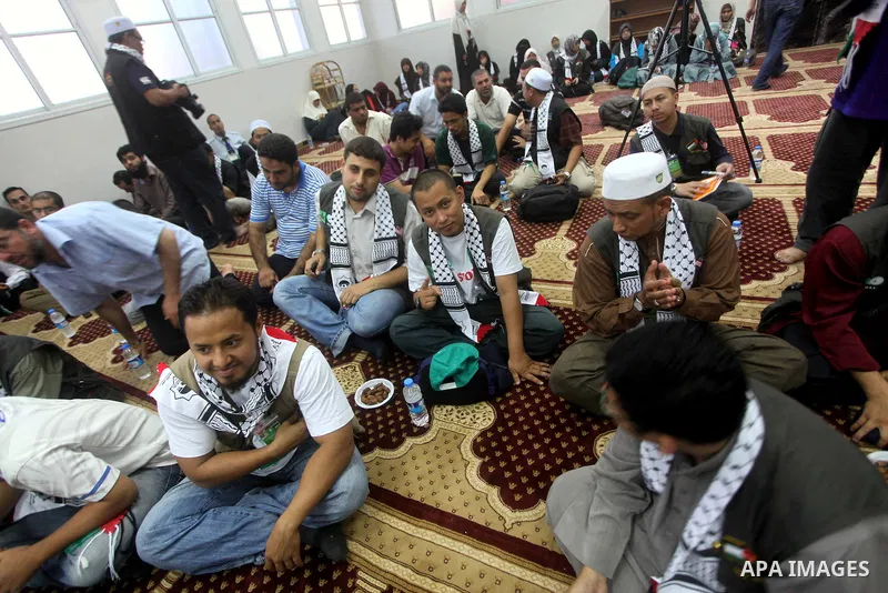 Members of " Miles of Smiles 15 " aid convoy meets with members of Palestinian Parliament at a mosque before breaking their fast during the holy month of Ramadan in Gaza city, on Aug 16, 2012. Photo by Ashraf Amra