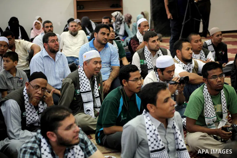 Members of " Miles of Smiles 15 " aid convoy meets with members of Palestinian Parliament at a mosque before breaking their fast during the holy month of Ramadan in Gaza city, on Aug 16, 2012. Photo by Ashraf Amra