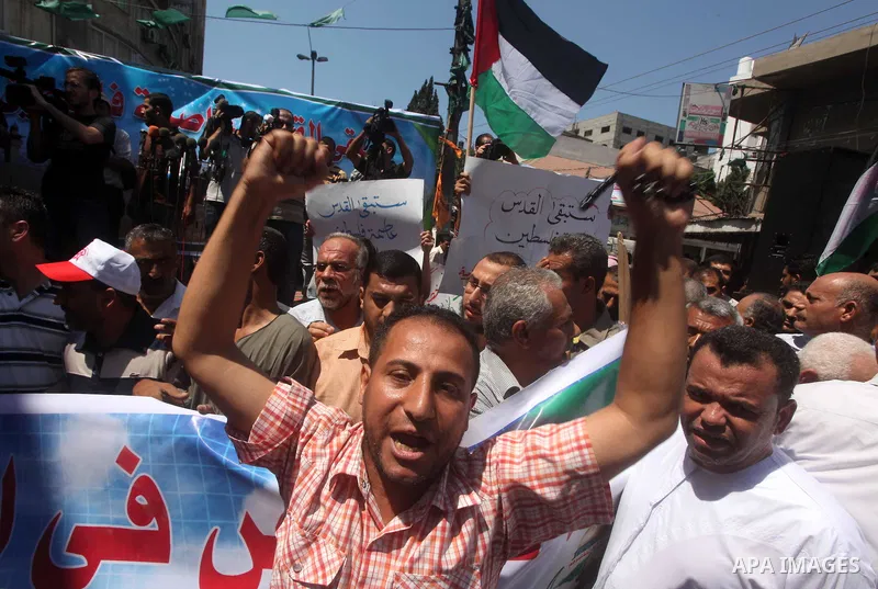 Palestinian demonstrators chant slogans during an annual rally marking Al-Quds Day (Jerusalem Day), on the last Friday of the holy month of Ramadan, in Gaza city, Friday, Aug. 17, 2012. Photo by Ashraf Amra