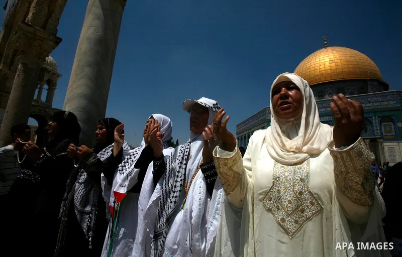 Palestinian Muslim women pray outside the Dome of the Rock at al-Aqsa mosque compound, Islam's third holiest site, on August 17, 2012, in the old city of Jerusalem, on the last Friday of the Muslim holy fasting month of...