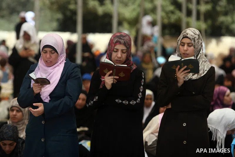 Palestinian women worshippers pray outside the Dome of the Rock at al-Aqsa mosque compound, Islam's third holiest site, on August 17, 2012, in the old city of Jerusalem, on the last Friday of the Muslim holy fasting mont...
