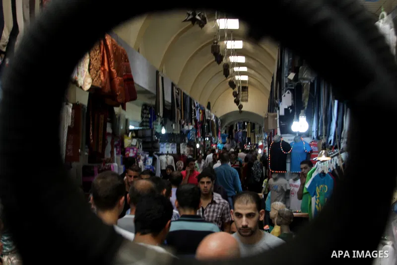 Palestinians shop at market during preparations for the Eid Al-Fitr feast in the West Bank city of Nablus on Aug 18, 2012, as Muslims over the world prepare to celebrate Eid al-Fitr, a three day holiday marking the end o...