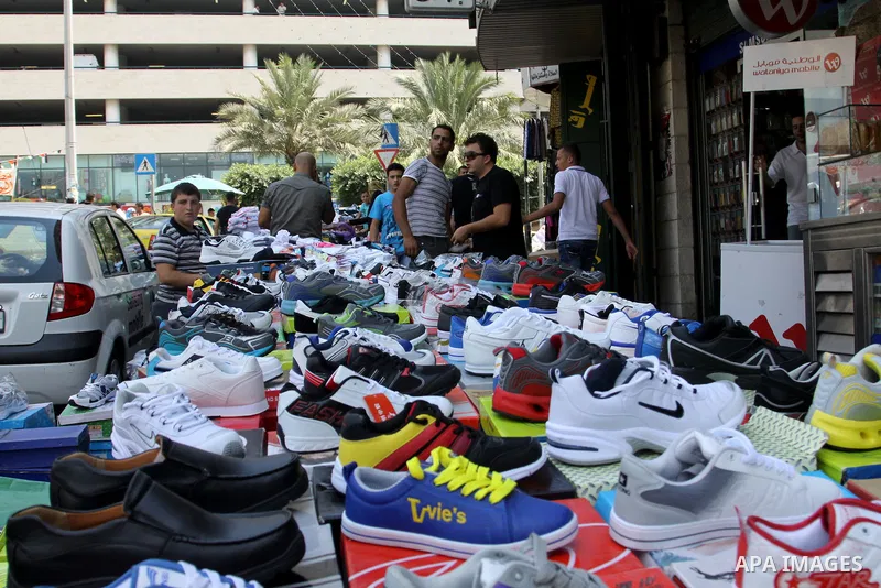 Palestinians shop at market during preparations for the Eid Al-Fitr feast in the West Bank city of Nablus on Aug 18, 2012, as Muslims over the world prepare to celebrate Eid al-Fitr, a three day holiday marking the end o...