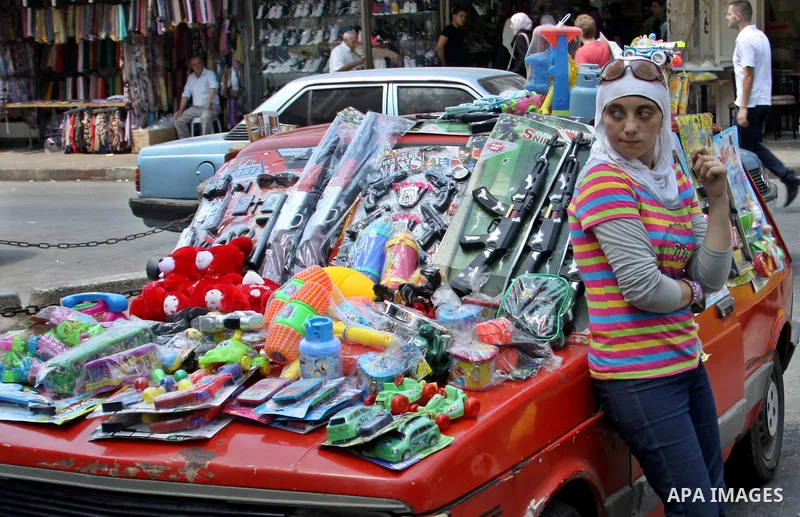 Palestinians shop at market during preparations for the Eid Al-Fitr feast in the West Bank city of Nablus on Aug 18, 2012, as Muslims over the world prepare to celebrate Eid al-Fitr, a three day holiday marking the end o...