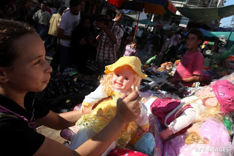 Palestinians buy toys at the main market during preparations for the Eid Al-Fitr feast Gaza city on Aug 18, 2012, as Muslims over the world prepare to celebrate Eid al-Fitr, a three day holiday marking the end of the rel...