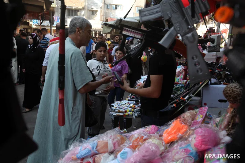 Palestinians buy toys at the main market during preparations for the Eid Al-Fitr feast Gaza city on Aug 18, 2012, as Muslims over the world prepare to celebrate Eid al-Fitr, a three day holiday marking the end of the rel...