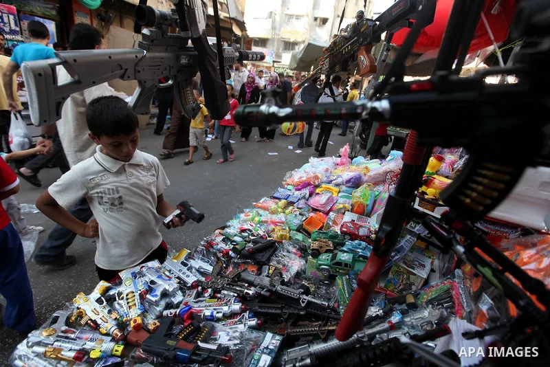 Palestinians buy toys at the main market during preparations for the Eid Al-Fitr feast Gaza city on Aug 18, 2012, as Muslims over the world prepare to celebrate Eid al-Fitr, a three day holiday marking the end of the rel...