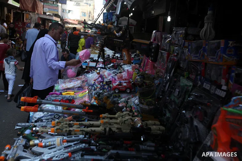 Palestinians buy toys at the main market during preparations for the Eid Al-Fitr feast Gaza city on Aug 18, 2012, as Muslims over the world prepare to celebrate Eid al-Fitr, a three day holiday marking the end of the rel...