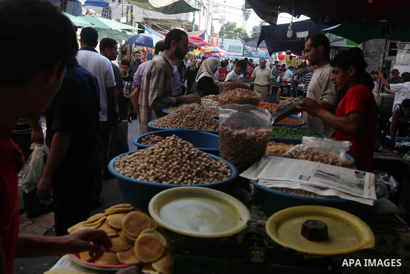A Palestinian vendor displays the nuts at the main market during preparations for the Eid Al-Fitr feast Gaza city on Aug 18, 2012, as Muslims over the world prepare to celebrate Eid al-Fitr, a three day holiday marking t...
