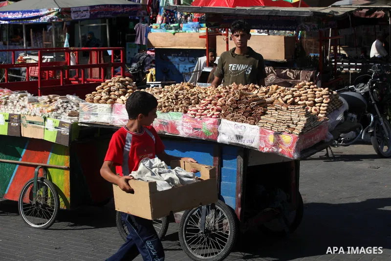A Palestinian vendor displays the cakes at the main market during preparations for the Eid Al-Fitr feast Gaza city on Aug 18, 2012, as Muslims over the world prepare to celebrate Eid al-Fitr, a three day holiday marking...