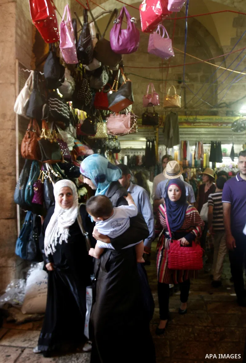 Palestinians shop at the market during preparations for the Eid Al-Fitr feast in Jerusalem's Old City on Aug 16, 2012, as Muslims over the world prepare to celebrate Eid al-Fitr, a three day holiday marking the end of th...