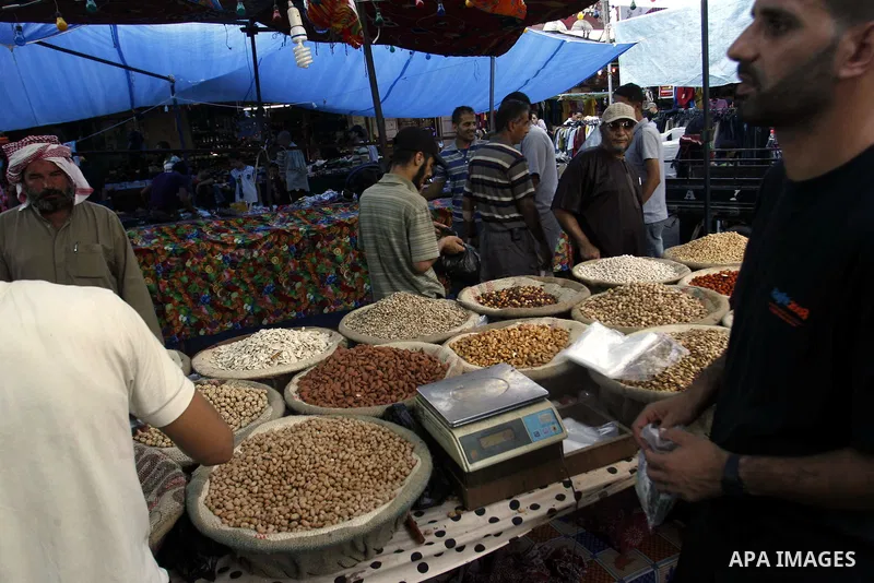 A Palestinian vendor sells nuts in the market during preparations for the Eid Al-Fitr feast in Rafah in the southern of Gaza strip on Aug 16, 2012, as Muslims over the world prepare to celebrate Eid al-Fitr, a three day...