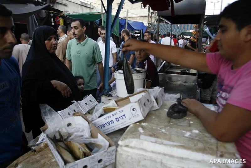 A Palestinian vendor sells salted fish in the market during preparations for the Eid Al-Fitr feast in Rafah in the southern of Gaza strip on Aug 16, 2012, as Muslims over the world prepare to celebrate Eid al-Fitr, a thr...