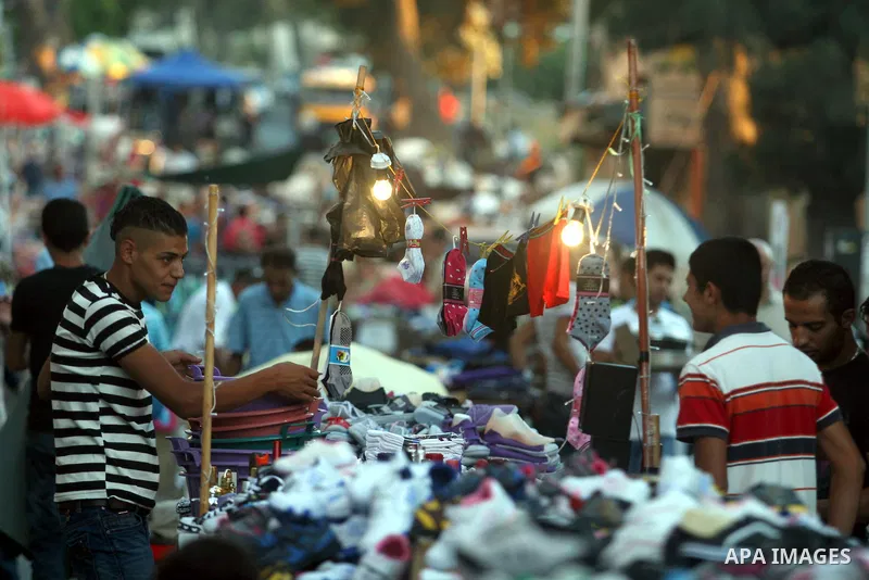 A Palestinian vendor displays his goods in the market during preparations for the Eid Al-Fitr feast in the West Bank city of Ramallah, on Aug 16, 2012, as Muslims over the world prepare to celebrate Eid al-Fitr, a three...