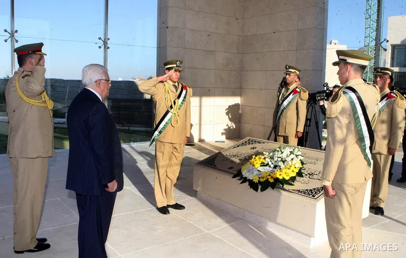 Palestinian President Mahmoud Abbas puts a wreath on the tomb of Yasser Arafat, PLO chairman and former Palestinian President, in the West Bank city of Ramallah on on Aug. 19, 2012, marking the Eid al-Fitr holiday. Musli...