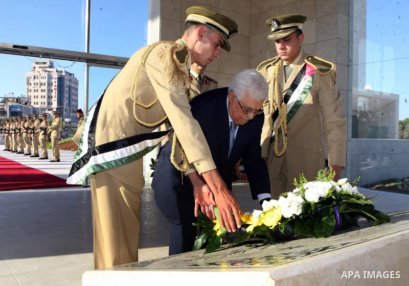 Palestinian President Mahmoud Abbas puts a wreath on the tomb of Yasser Arafat, PLO chairman and former Palestinian President, in the West Bank city of Ramallah on on Aug. 19, 2012, marking the Eid al-Fitr holiday. Musli...