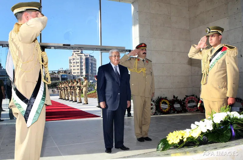 Palestinian President Mahmoud Abbas puts a wreath on the tomb of Yasser Arafat, PLO chairman and former Palestinian President, in the West Bank city of Ramallah on on Aug. 19, 2012, marking the Eid al-Fitr holiday. Musli...