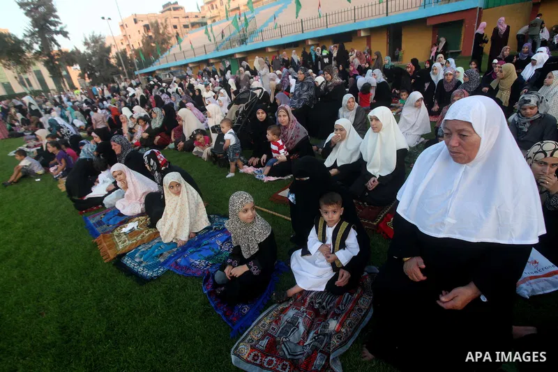 Palestinians attend Eid al-Fitr prayers at the Palestine Stadium in Gaza City August 19, 2012. Eid al-Fitr marks the end of the Muslim holy month of Ramadan. Photo by Ashraf Amra