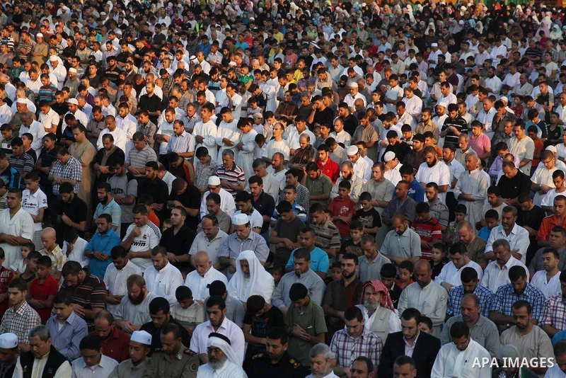 Palestinians attend Eid al-Fitr prayers at the Palestine Stadium in Gaza City August 19, 2012. Eid al-Fitr marks the end of the Muslim holy month of Ramadan. Photo by Ashraf Amra