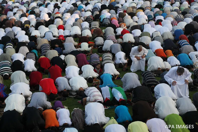 Palestinians attend Eid al-Fitr prayers at the Palestine Stadium in Gaza City August 19, 2012. Eid al-Fitr marks the end of the Muslim holy month of Ramadan. Photo by Ashraf Amra