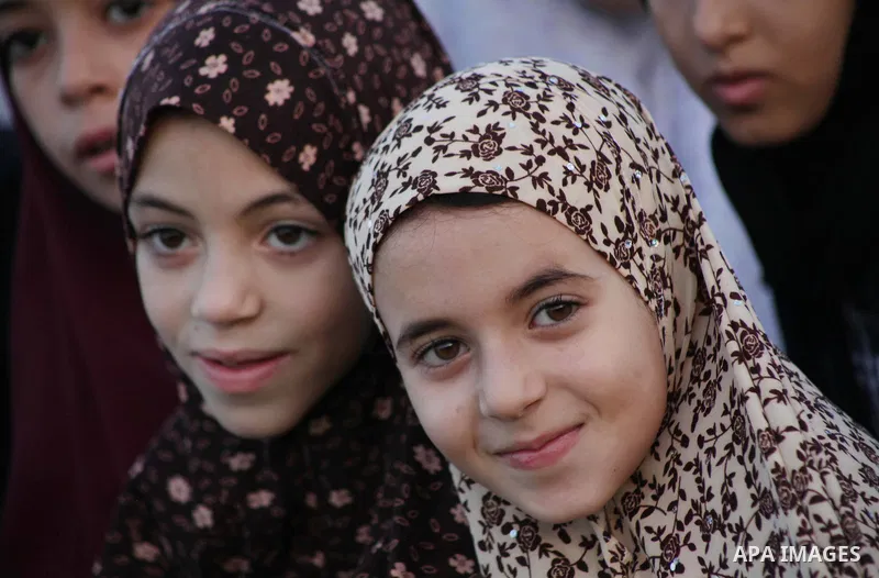 Palestinians attend Eid al-Fitr prayers at the Palestine Stadium in Gaza City August 19, 2012. Eid al-Fitr marks the end of the Muslim holy month of Ramadan. Photo by Ashraf Amra