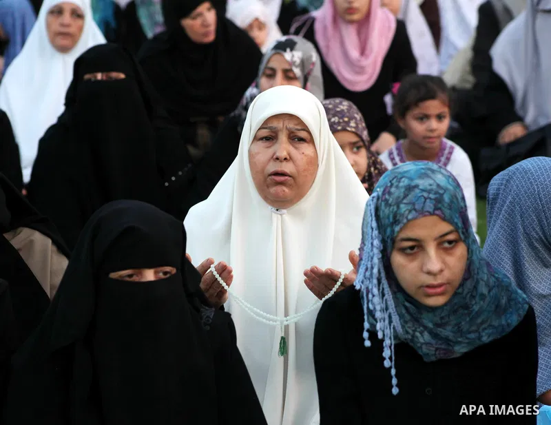 Palestinians attend Eid al-Fitr prayers at the Palestine Stadium in Gaza City August 19, 2012. Eid al-Fitr marks the end of the Muslim holy month of Ramadan. Photo by Ashraf Amra