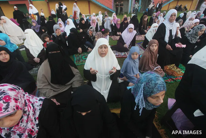 Palestinians attend Eid al-Fitr prayers at the Palestine Stadium in Gaza City August 19, 2012. Eid al-Fitr marks the end of the Muslim holy month of Ramadan. Photo by Ashraf Amra