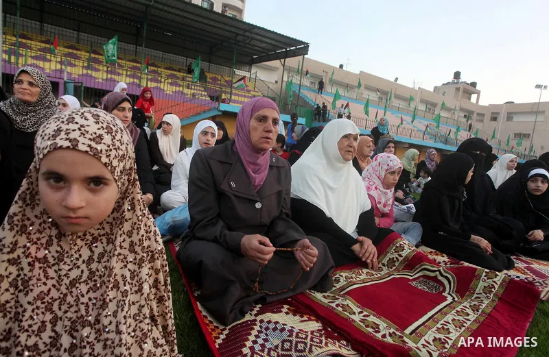 Palestinians attend Eid al-Fitr prayers at the Palestine Stadium in Gaza City August 19, 2012. Eid al-Fitr marks the end of the Muslim holy month of Ramadan. Photo by Ashraf Amra