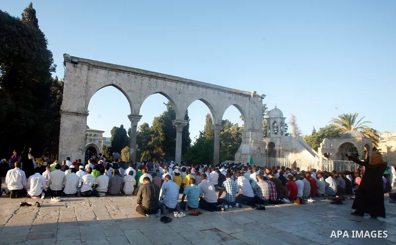 Palestinians attend the Eid al-Fitr prayers at al-Aqsa mosque in Jerusalem's Old City, Sunday, Aug. 19, 2012. Muslims are celebrating the festival of Eid al-Fitr which marks the end of the holy fasting month of Ramadan....