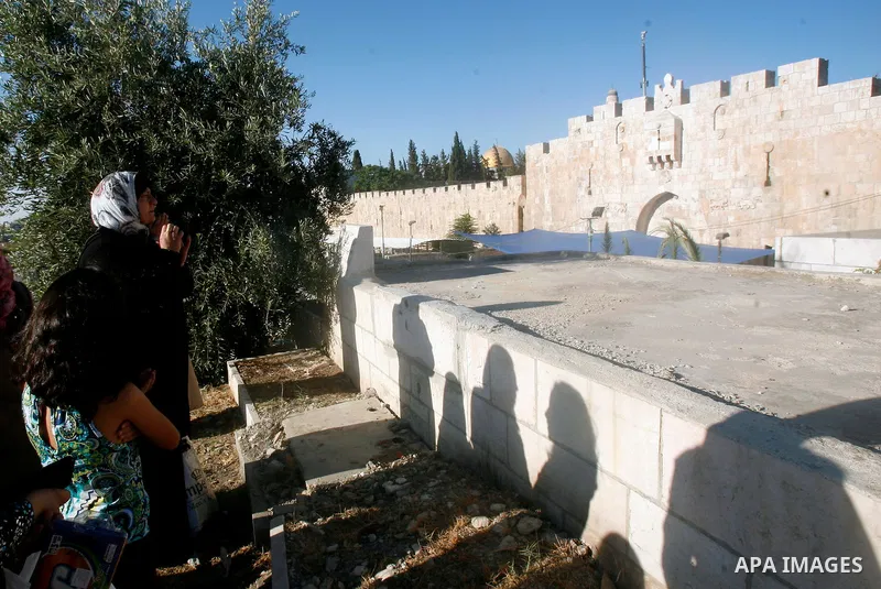 An elderly Palestinian prays next to a grave in a cemetery as part of the Eid al-Fitr traditions in Jerusalem's Old City, Sunday, Aug. 19, 2012. Muslims are celebrating the festival of Eid al-Fitr which marks the end of...