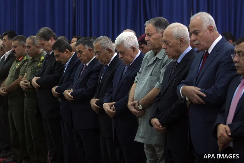 Palestinian President Mahmoud Abbas and his Prime Minister Salam Fayyad attend the early morning Eid Al-Fitr prayer at the Palestinian Authority headquarters in the West Bank city of Ramallah on Aug. 19, 2012 . Muslims o...