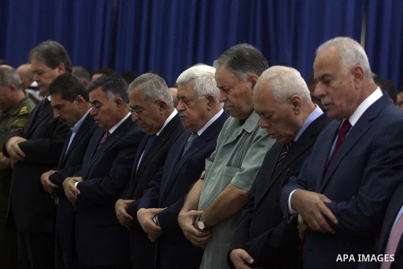 Palestinian President Mahmoud Abbas and his Prime Minister Salam Fayyad attend the early morning Eid Al-Fitr prayer at the Palestinian Authority headquarters in the West Bank city of Ramallah on Aug. 19, 2012 . Muslims o...