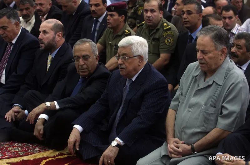 Palestinian President Mahmoud Abbas and his Prime Minister Salam Fayyad attend the early morning Eid Al-Fitr prayer at the Palestinian Authority headquarters in the West Bank city of Ramallah on Aug. 19, 2012 . Muslims o...
